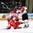 GRAND FORKS, NORTH DAKOTA - APRIL 15: Canada's David Quenneville #18 knocks down Denmark's Daniel Nielsen #19 during preliminary round action at the 2016 IIHF Ice Hockey U18 World Championship. (Photo by Minas Panagiotakis/HHOF-IIHF Images)

